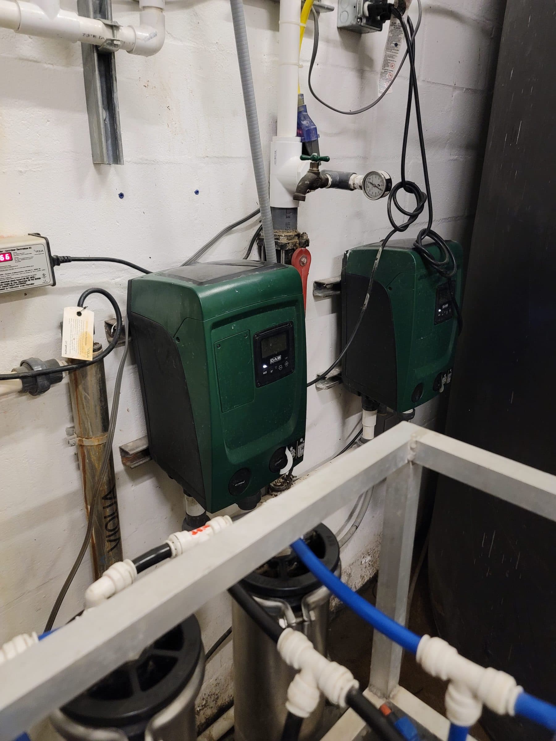 Commercial booster pumps and UV disinfection equipment installed on a rack