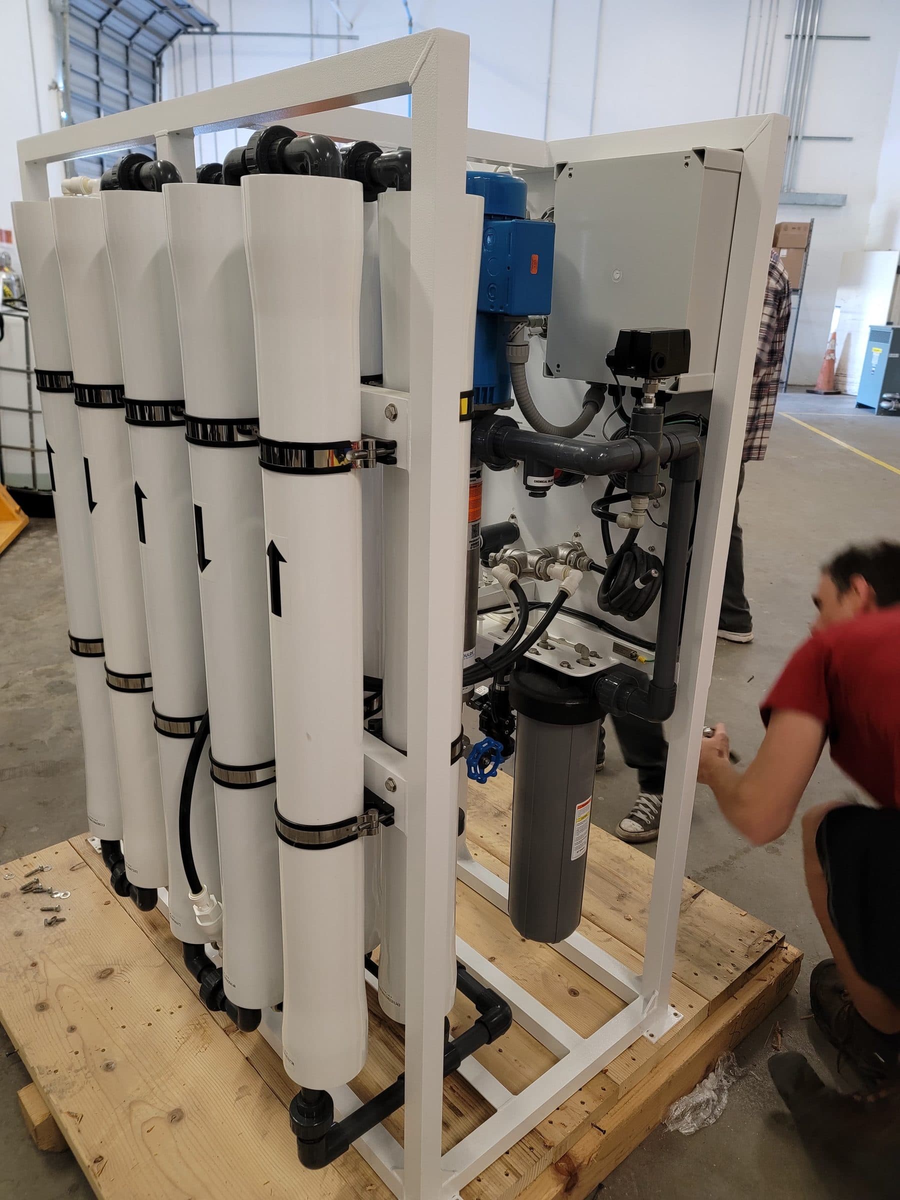 Commercial reverse osmosis membrane skid with filter housings being built and tested