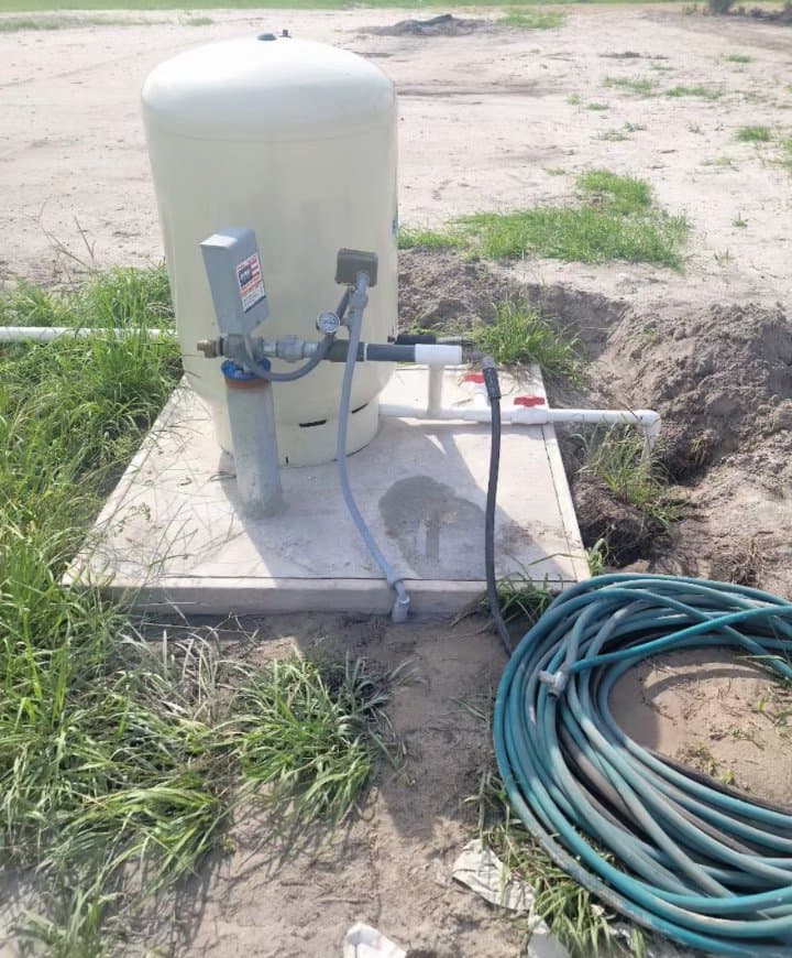 New well pressure tank installed on a fresh concrete pad